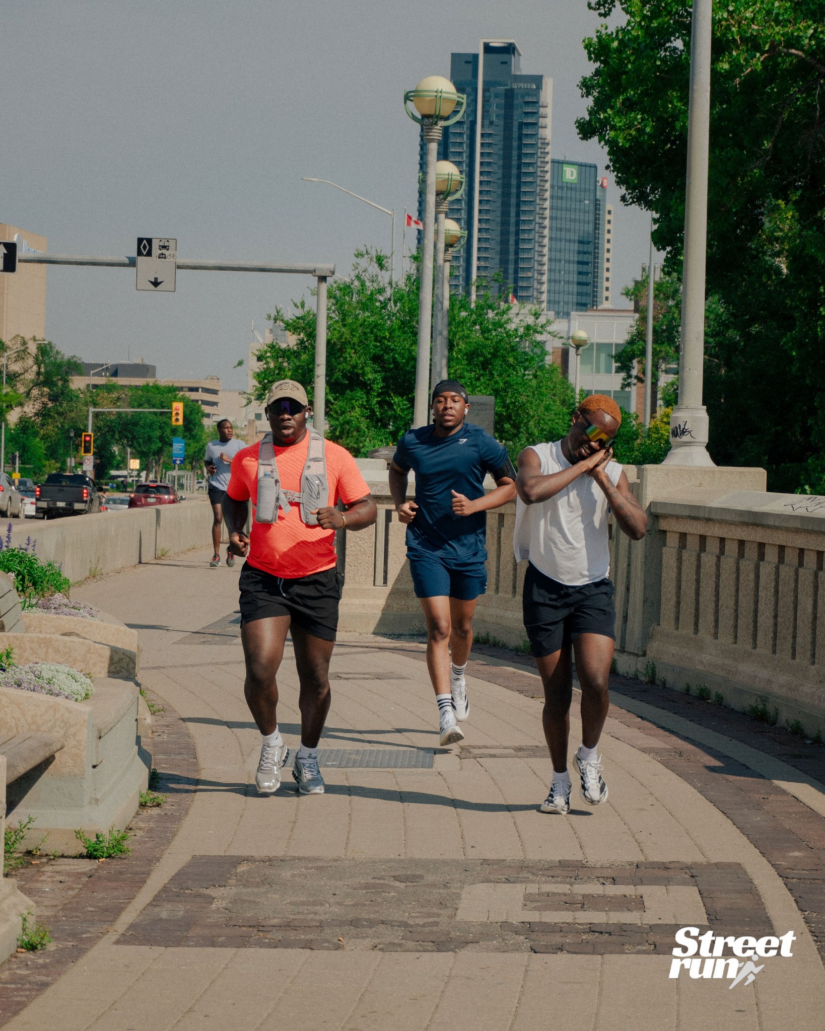 Street Run Club runners moving through downtown Winnipeg